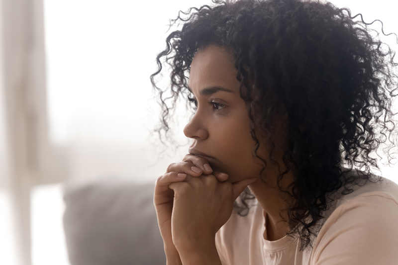 woman looking off to the side with a serious look on her face